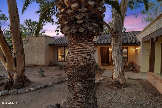 view of front of home featuring a tile roof and stucco siding