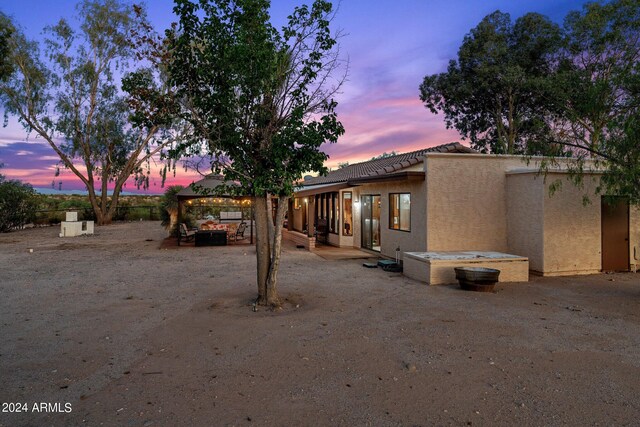 back of house with a patio area and stucco siding