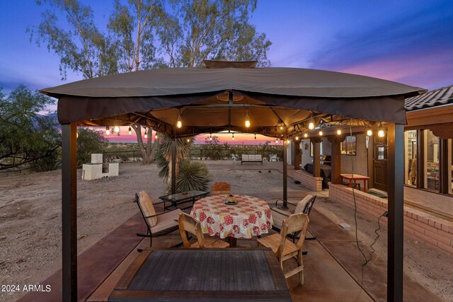 view of patio terrace at dusk