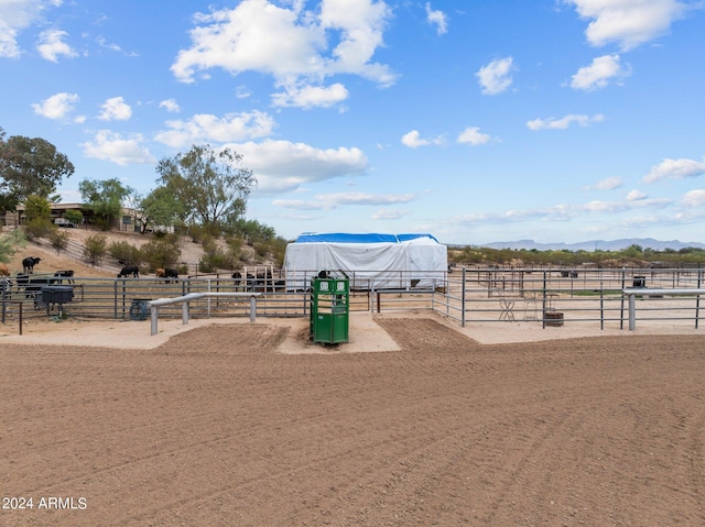 surrounding community with a rural view, an outbuilding, an enclosed area, an exterior structure, and a mountain view