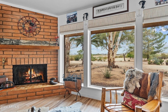 living area with a fireplace and wood finished floors