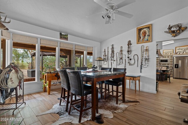 dining space featuring ceiling fan, a wealth of natural light, and light hardwood / wood-style floors