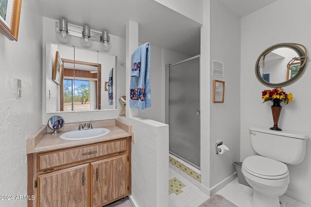 bathroom with walk in shower, toilet, tile patterned floors, and vanity