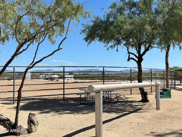 view of home's community featuring a mountain view and fence