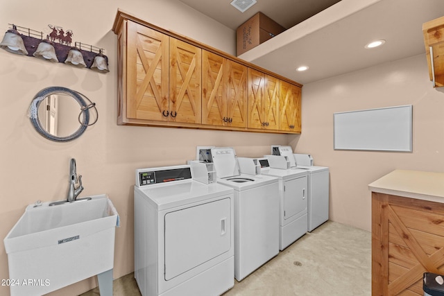 washroom with recessed lighting, cabinet space, visible vents, a sink, and separate washer and dryer