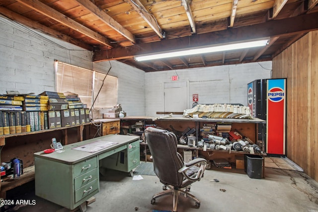 office featuring a workshop area, wooden ceiling, wooden walls, and concrete floors