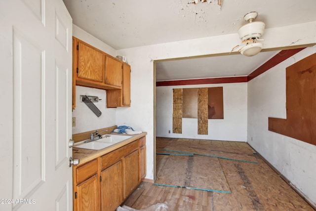 kitchen featuring sink, ceiling fan, and hardwood / wood-style floors