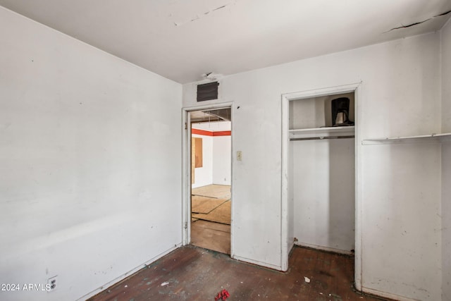 unfurnished bedroom with a closet and wood-type flooring