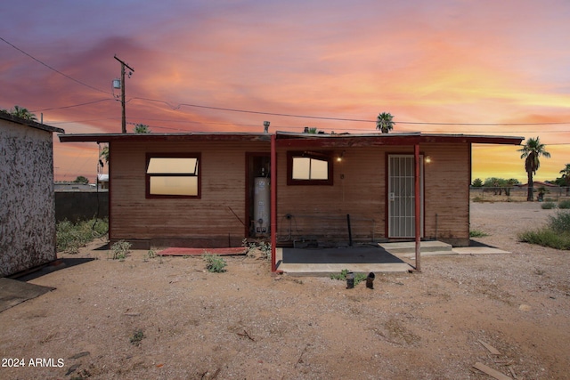 view of front facade with a patio area and water heater