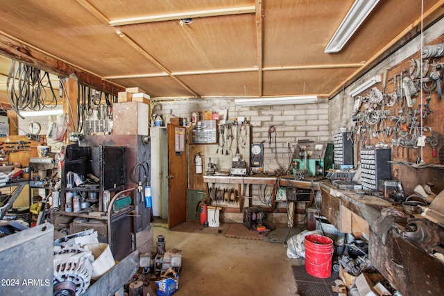 miscellaneous room featuring concrete floors and a workshop area