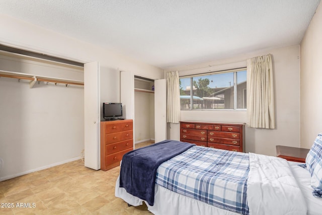 500 W Clarendon Ave Unit B11, Phoenix, AZ 85014 - bedroom with two closets and baseboards