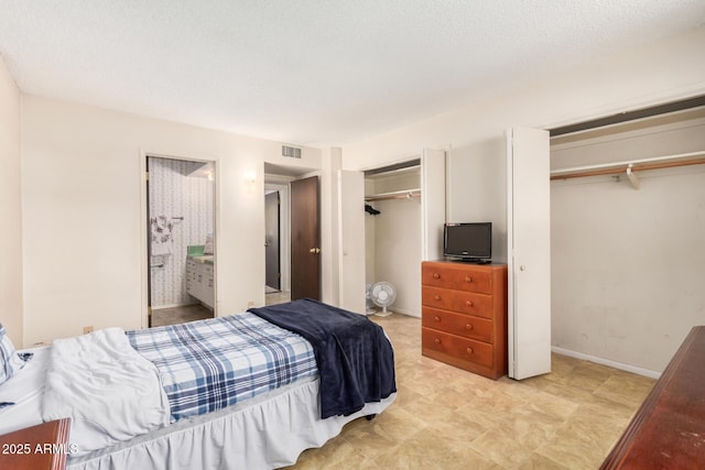 500 W Clarendon Ave Unit B11, Phoenix, AZ 85014 - bedroom with two closets and baseboards