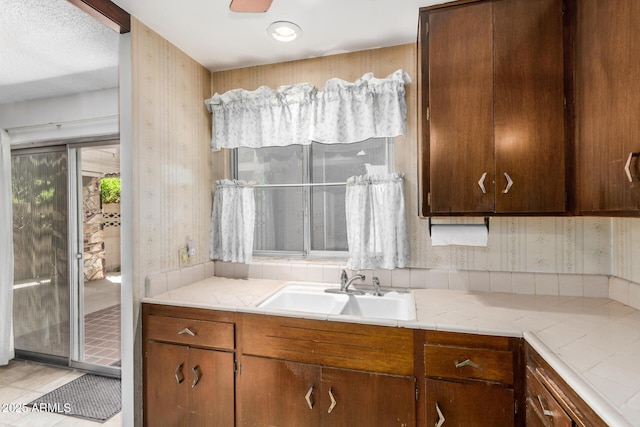 500 W Clarendon Ave Unit B11, Phoenix, AZ 85014 - kitchen with wallpapered walls, light countertops, and tile patterned flooring