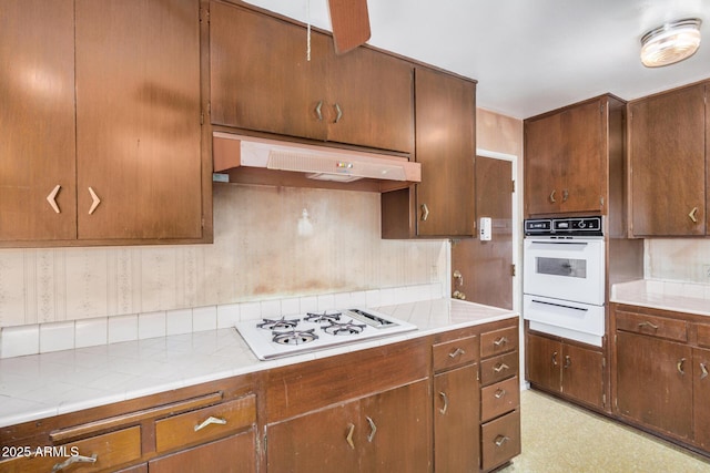 500 W Clarendon Ave Unit B11, Phoenix, AZ 85014 - kitchen featuring extractor fan, white appliances, a warming drawer, tile countertops, and light floors