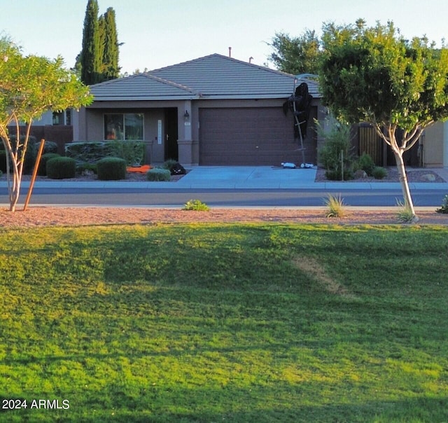 view of front of house with a garage and a front lawn