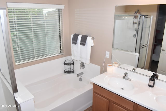 bathroom with shower with separate bathtub and vanity