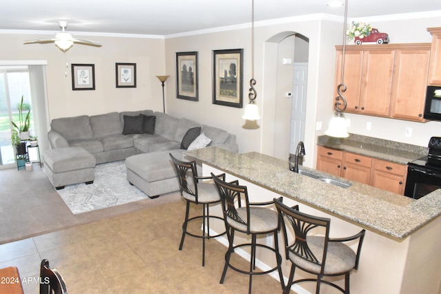 kitchen with black appliances, sink, ornamental molding, kitchen peninsula, and a breakfast bar area