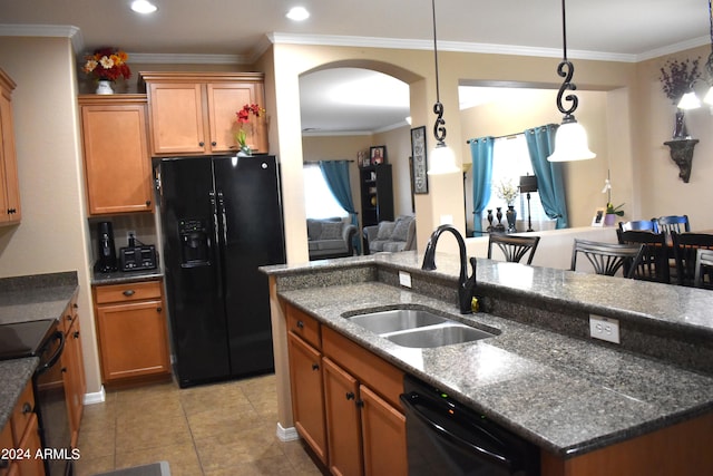 kitchen featuring pendant lighting, sink, dark stone countertops, and black appliances