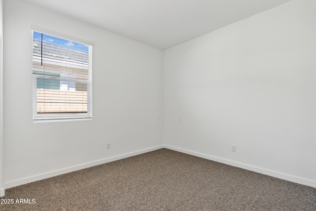 carpeted spare room with baseboards
