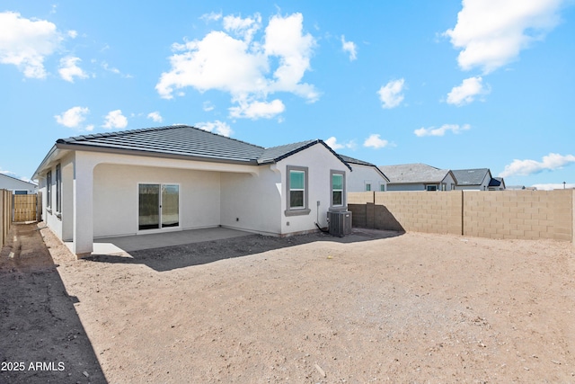 back of property featuring stucco siding, a fenced backyard, cooling unit, a patio area, and a tiled roof