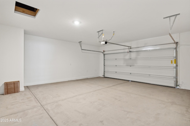 garage with baseboards, a garage door opener, and visible vents