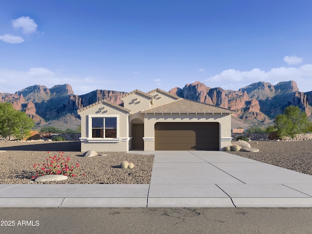 view of front of property with a garage, stucco siding, a tiled roof, a mountain view, and driveway