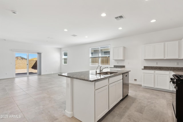 kitchen featuring visible vents, dishwasher, a sink, black gas range, and dark stone counters