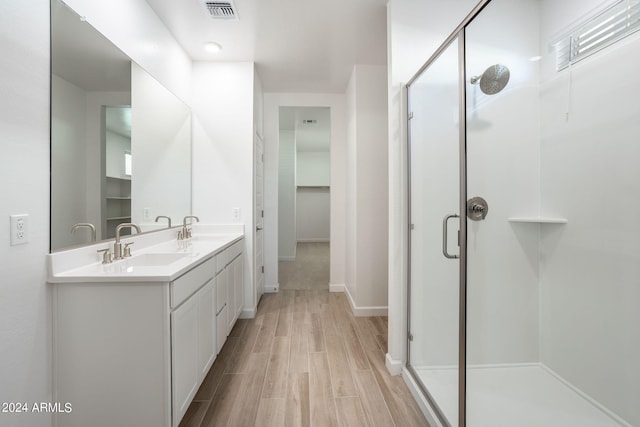 bathroom with vanity, hardwood / wood-style flooring, and walk in shower