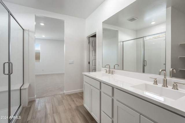 bathroom featuring vanity, a shower with door, and hardwood / wood-style floors