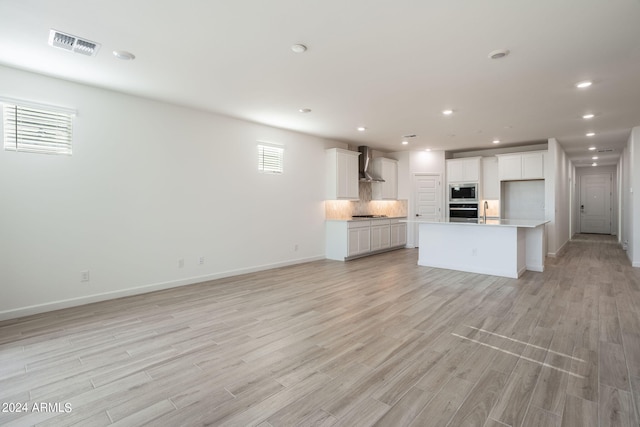 unfurnished living room with light hardwood / wood-style floors