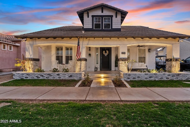 view of front facade featuring covered porch and a tile roof