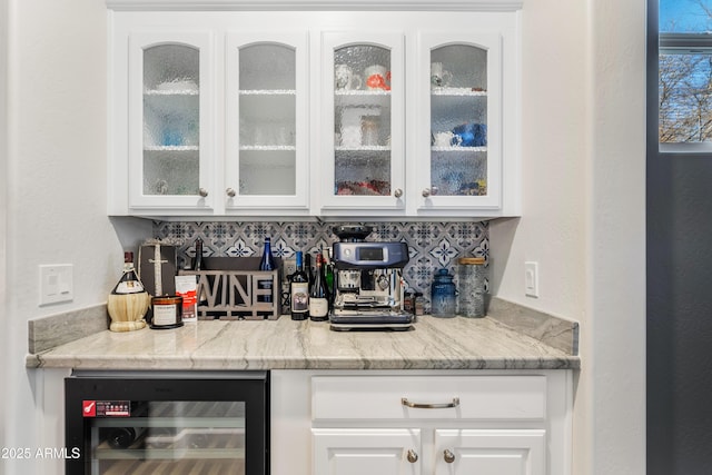 bar with a bar, wine cooler, and backsplash