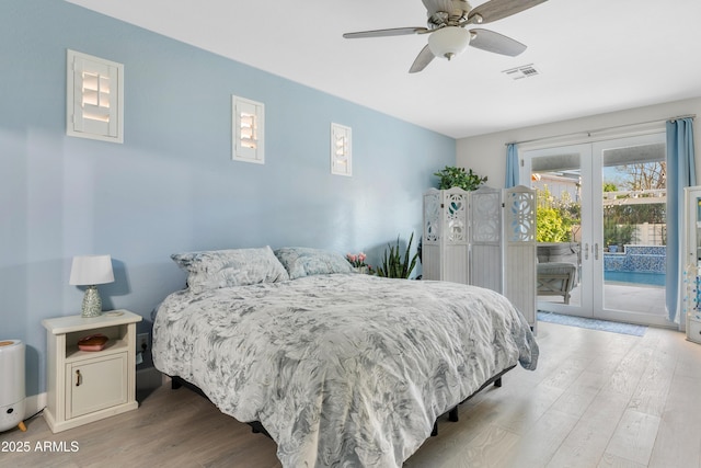 bedroom featuring wood finished floors, a ceiling fan, visible vents, access to exterior, and french doors