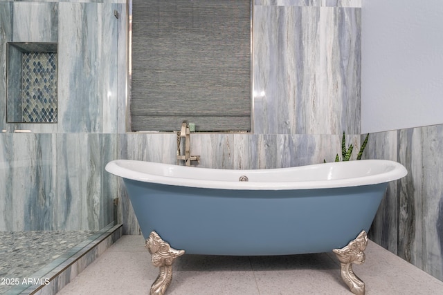 bathroom featuring a freestanding bath and tile walls