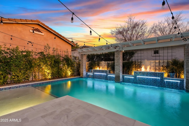 pool at dusk featuring a fenced backyard, an outdoor pool, and a patio