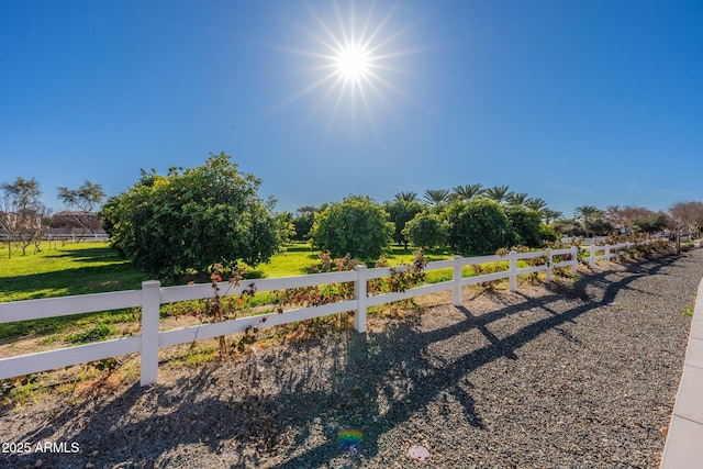 view of yard featuring fence and a rural view