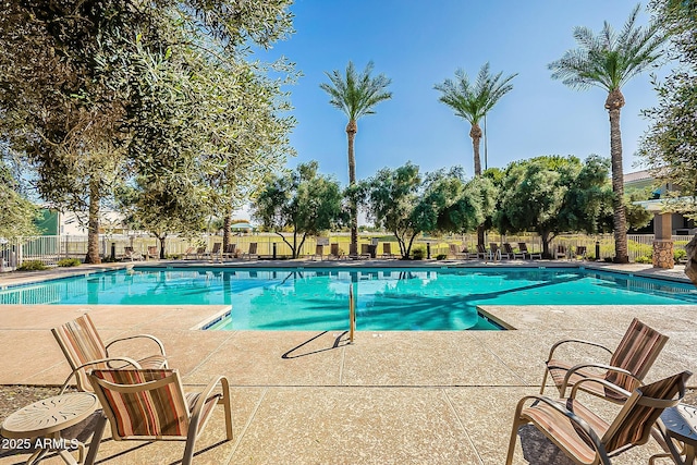 pool featuring fence and a patio