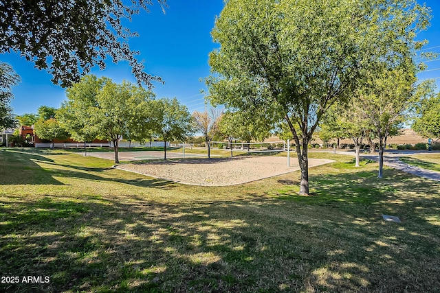 surrounding community with a yard and volleyball court