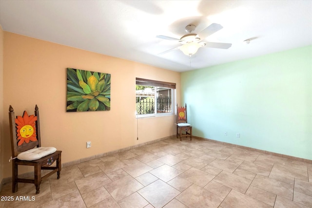 interior space with ceiling fan and baseboards