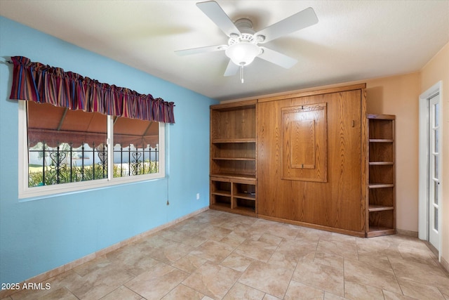 unfurnished bedroom with baseboards and ceiling fan