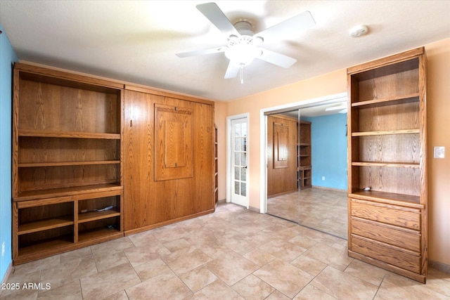 unfurnished bedroom featuring a closet, baseboards, and ceiling fan