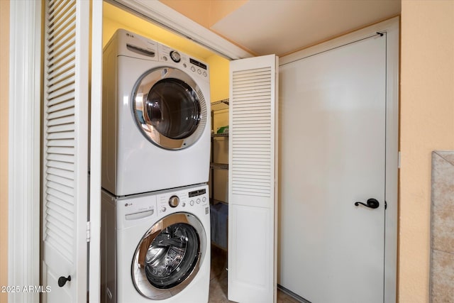 clothes washing area with stacked washer / dryer and laundry area