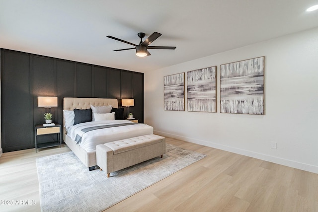 bedroom with baseboards, light wood-type flooring, and ceiling fan