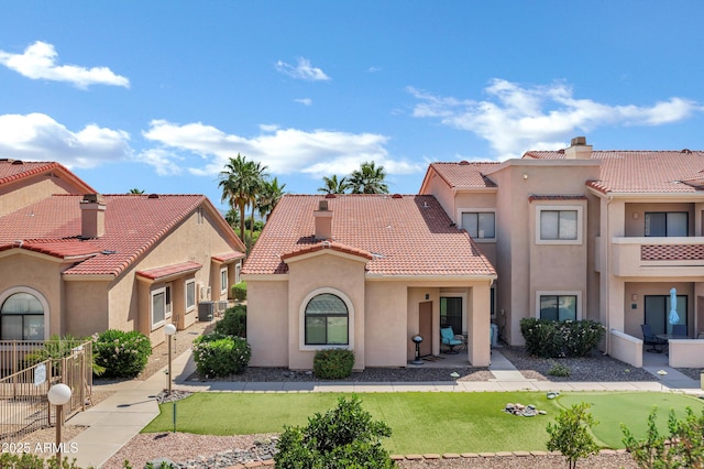 16357 E Arrow Dr Unit 115, Fountain Hills, AZ 85268 - view of front of property with stucco siding, a tile roof, a front lawn, and a chimney