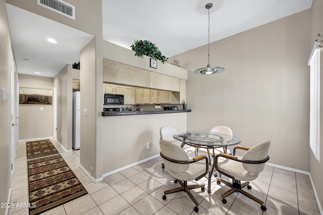 16357 E Arrow Dr Unit 115, Fountain Hills, AZ 85268 - dining area with light tile patterned flooring, high vaulted ceiling, and baseboards