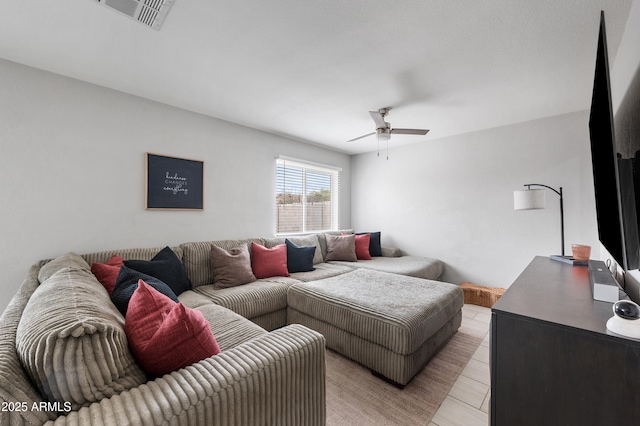 living area with visible vents and ceiling fan