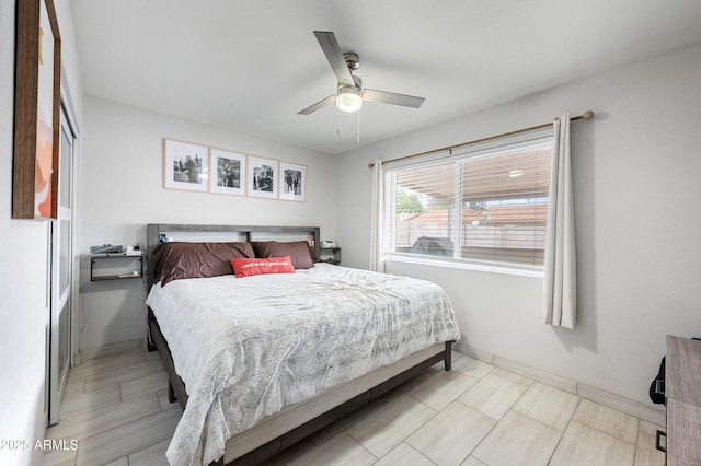 bedroom with baseboards and a ceiling fan