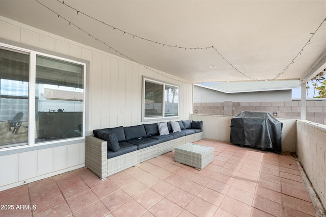 view of patio featuring outdoor lounge area, fence, and grilling area