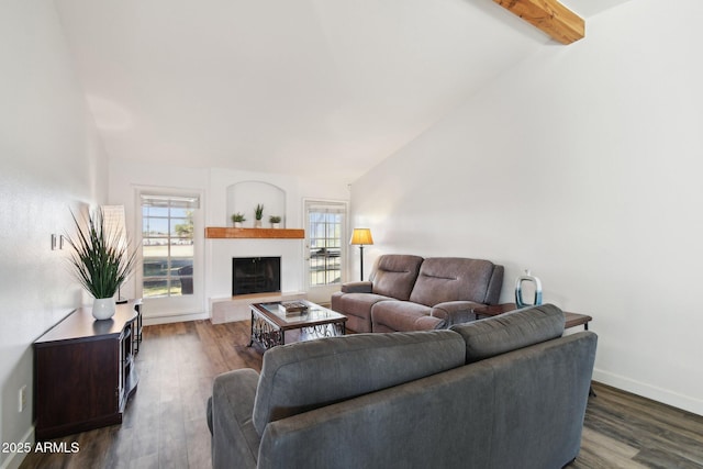 living area featuring lofted ceiling with beams, baseboards, and wood finished floors