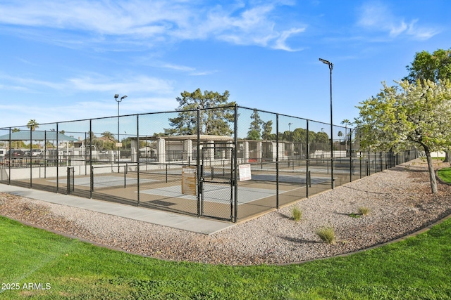 view of sport court featuring fence